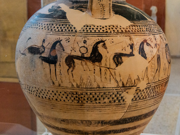 Amphora of the Geometric Period with a continuous, narrative frieze summarizing the sad fate of a warrior. Frieze side B, horsemen wearing crested helmets and armed with spear and shield. Paros, Archaeological Museum of Parikia